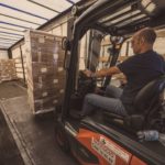 photo of man in forklift in factory