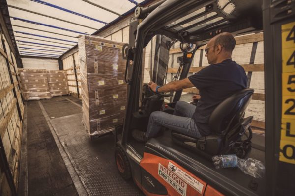 photo of man in forklift in factory