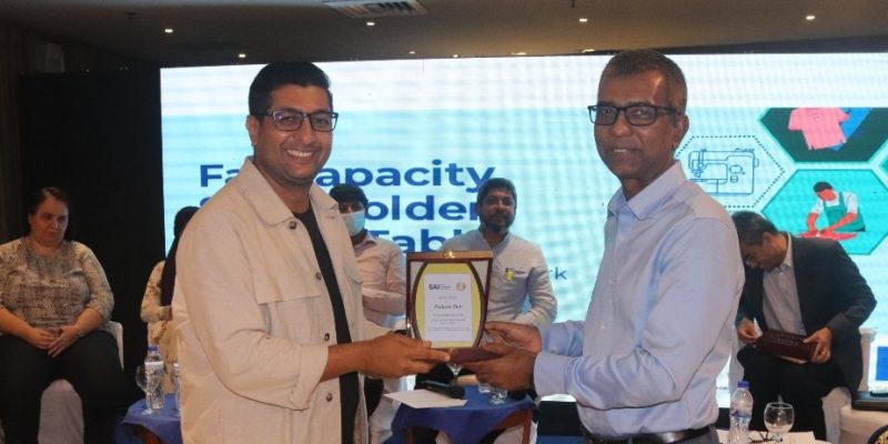 Prakash Dutt, Head of Quality Assurance and Corporate Social Responsibility at Asmara International Ltd., receiving a plaque for participation in the panel discussion.